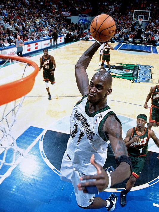 Dynamic action shot of Kevin Garnett soaring for a dunk, showcasing athleticism and intensity.