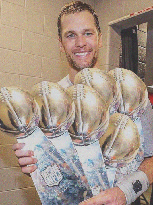 A vibrant poster showcasing Tom Brady holding multiple championship trophies, celebrating his legendary career.