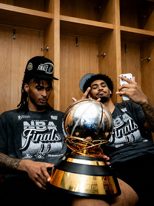 A colorful poster featuring Stephon Castle and Harper celebrating with a championship trophy, embodying the spirit of the San