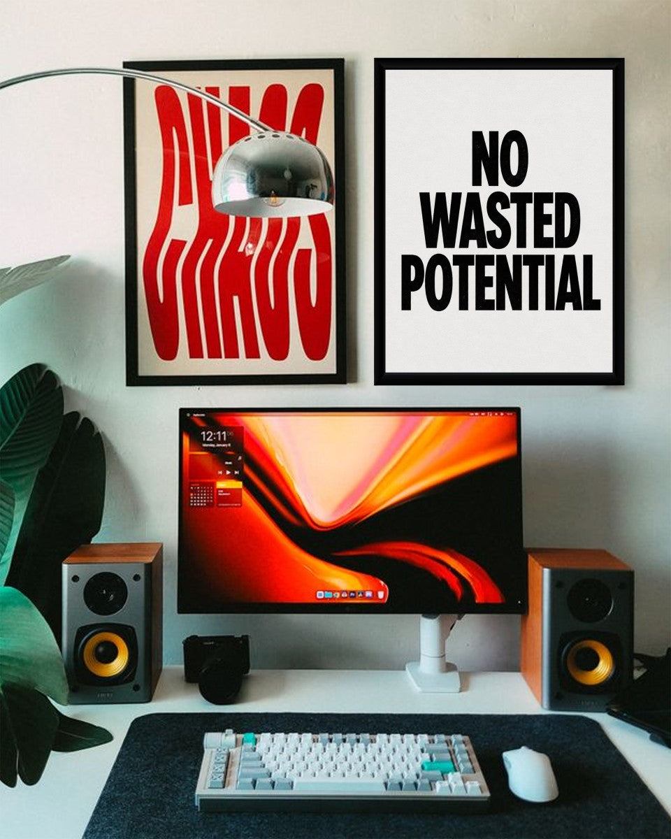 The No Wasted Potential poster presented in a styled office setting with contemporary decor.
