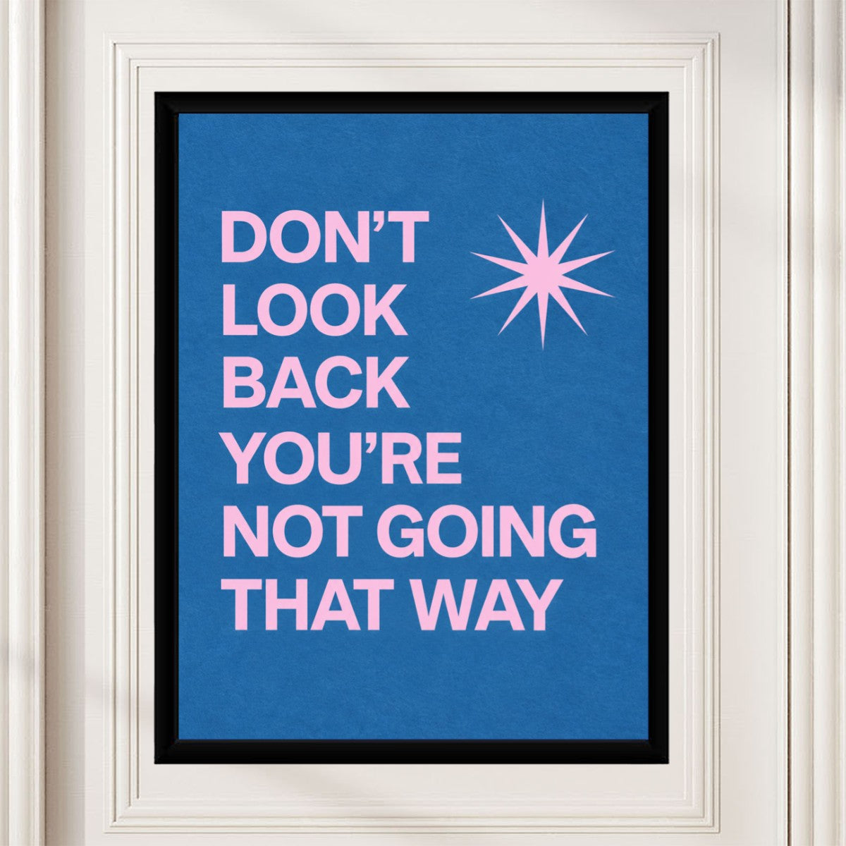 The 'Don't Look Back' poster displayed on a wall in a stylish mockup setting, offering a motivational vibe.