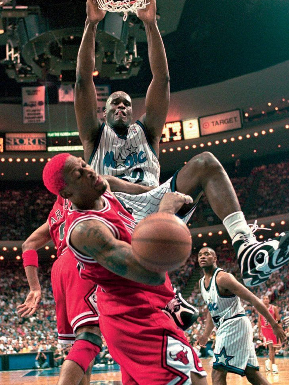 A vibrant poster featuring Shaquille O'Neal jumping over Dennis Rodman during an intense basketball game.