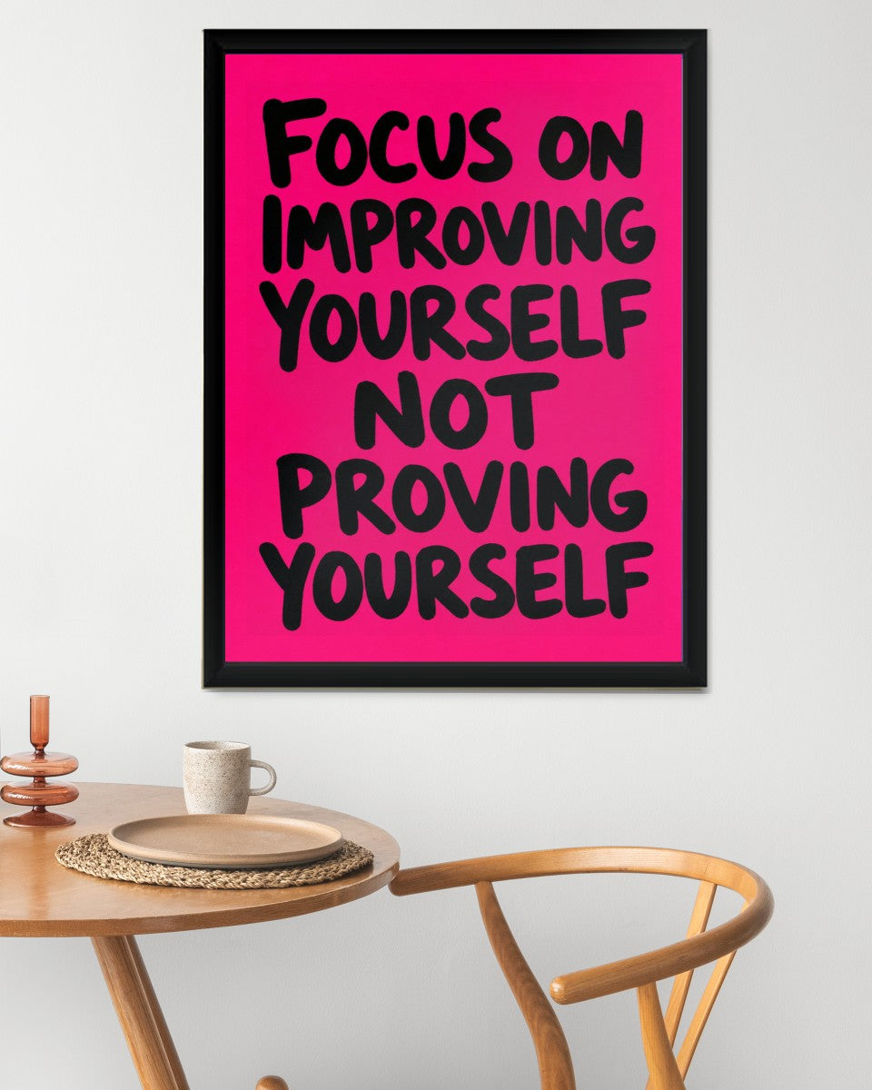 Vibrant 'Focus on Improving Yourself' poster showcased in a chic setting, enhancing the room's aesthetic.