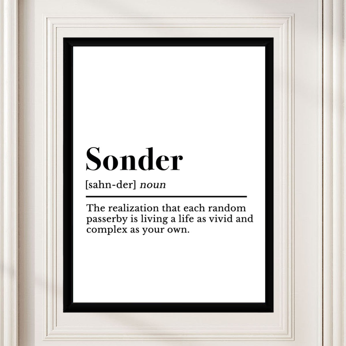 Sonder definition poster presented in a cozy living room arrangement.