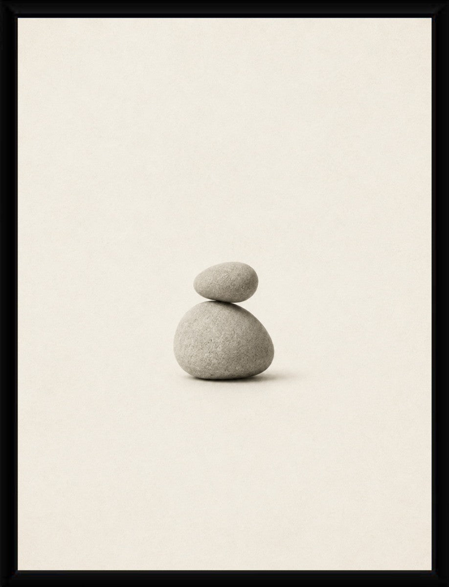 A minimalist balanced stones poster displayed in a sleek, modern frame.