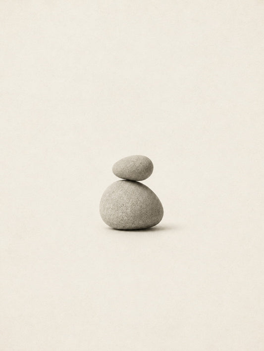 A minimalist poster featuring a harmonious arrangement of balanced stones in a neutral palette.