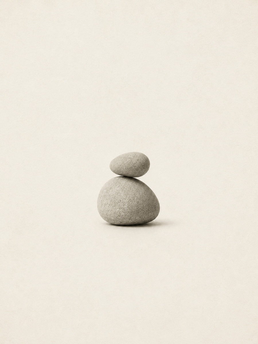 A minimalist poster featuring a harmonious arrangement of balanced stones in a neutral palette.
