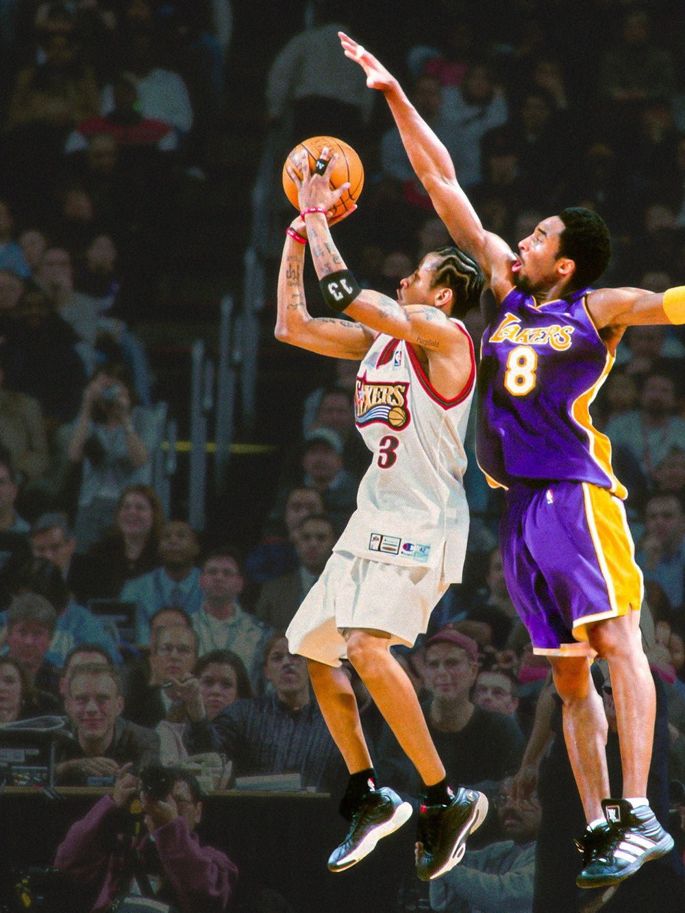 A colorful poster featuring Allen Iverson in a dynamic pose as he soars over Kobe Bryant, capturing an intense basketball
