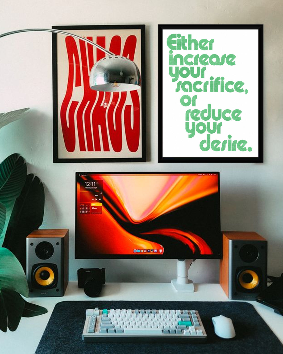 Motivational poster displayed on a styled desk, surrounded by modern workspace elements.