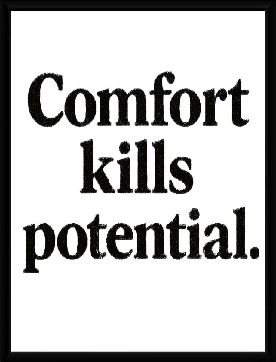 The 'Comfort kills potential' poster elegantly displayed in a sleek, modern frame, highlighting its minimalist style.
