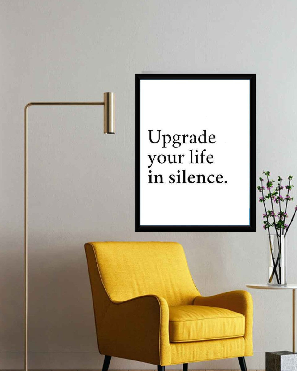 The 'Upgrade your life in silence.' poster displayed in a chic office setting.