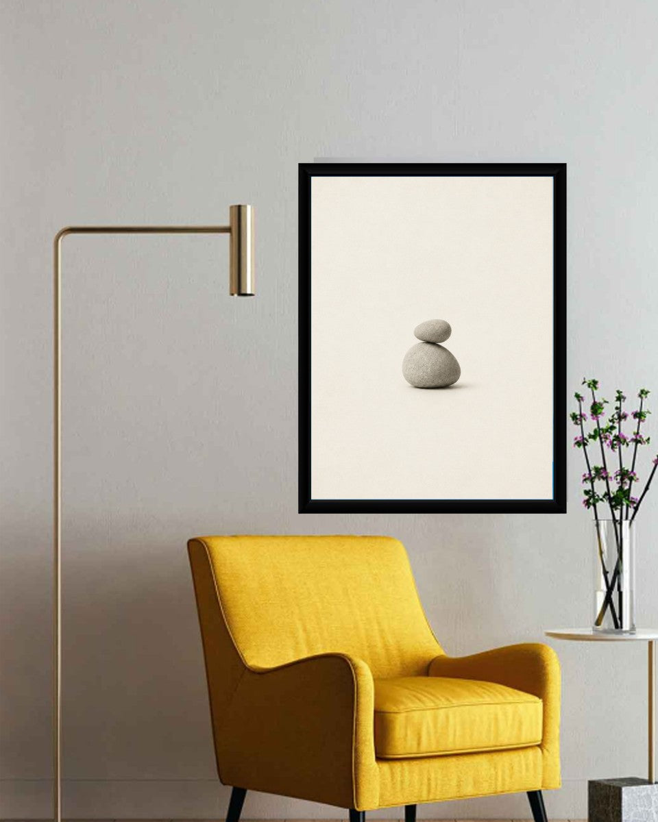 Balanced stones poster styled on a clean white wall with minimalist decor elements.
